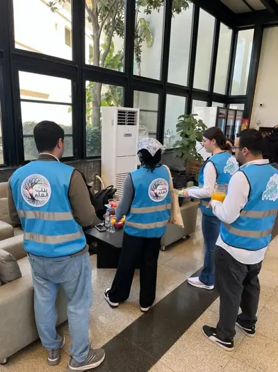 Volunteers in blue Ripple Act vests in a lounge