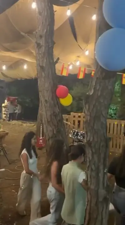 Guests dancing under a tent of string lights, flags and balloons on the World Cup final night