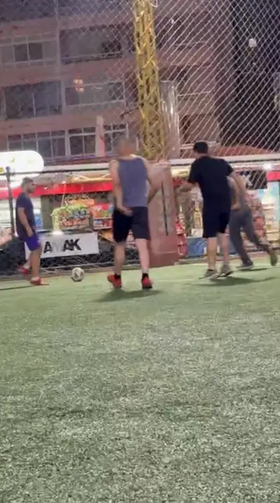 Players chasing the ball near the goal