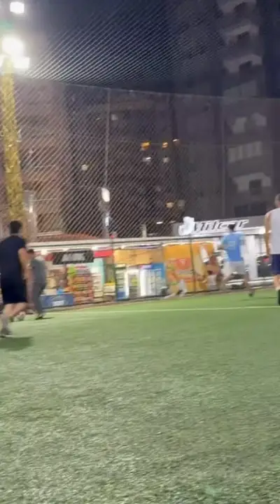Players on an artificial pitch at night
