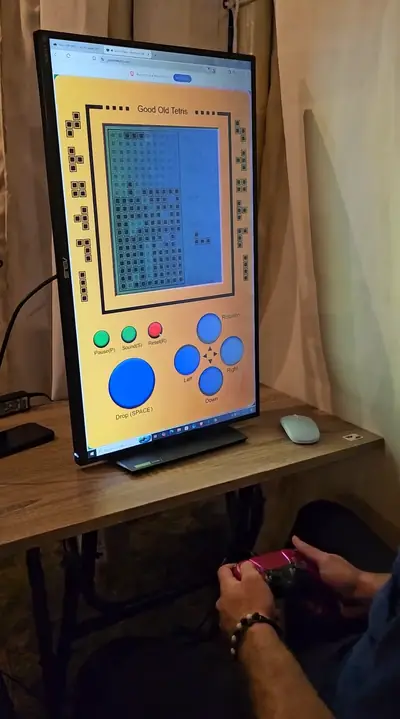 A retro game on a screen with a player holding a controller