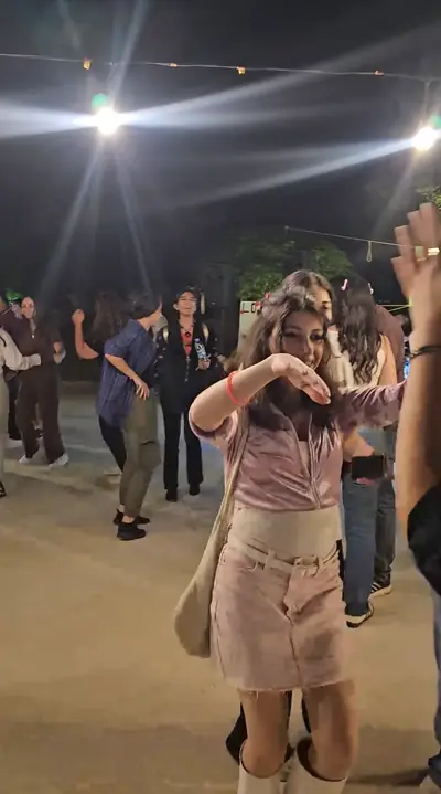 Guests dancing under floodlights