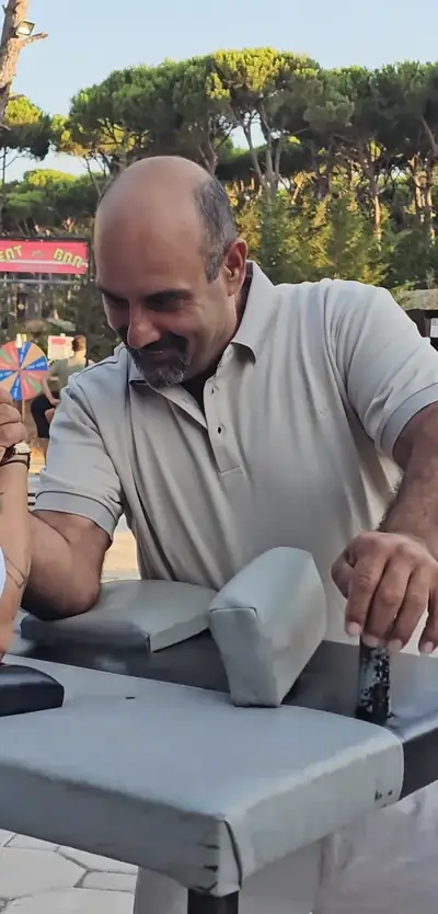 A man at an arm-wrestling table