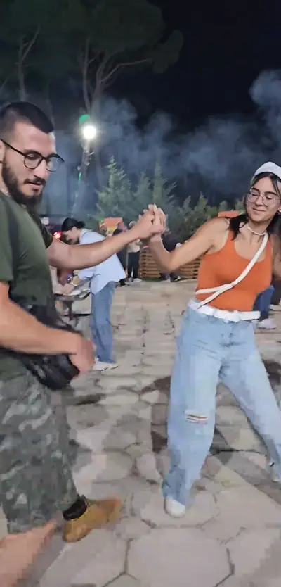 Two guests dancing dabke in the square