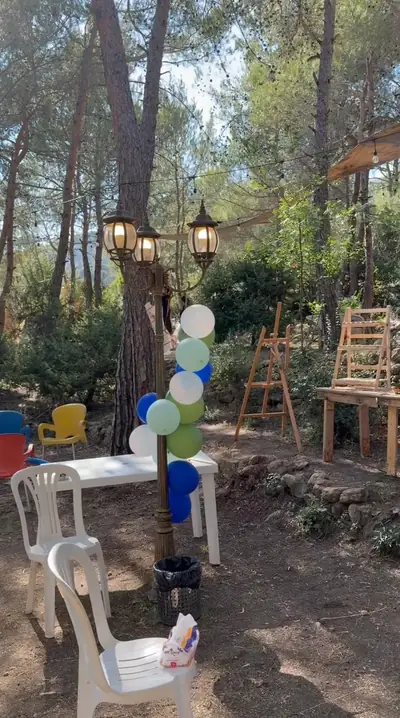 The forest venue being set up with tables, balloons and easels