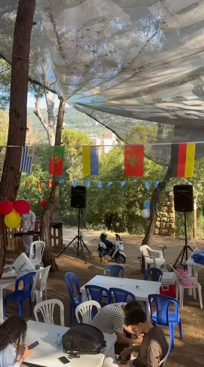 The forest venue dressed with flags, tables, chairs and speakers before the guests arrive