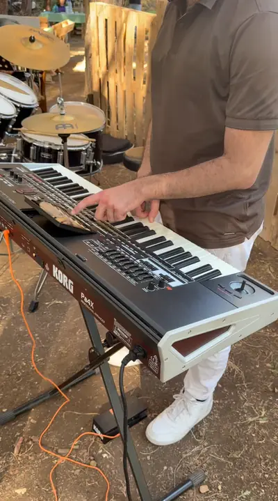A musician playing a keyboard outdoors
