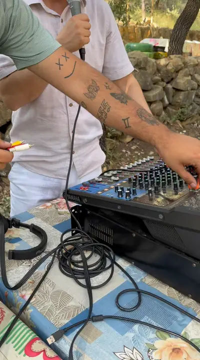 Hands adjusting a sound mixer