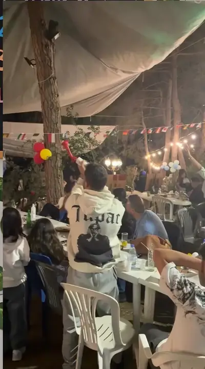 A crowd watching the final in the forest